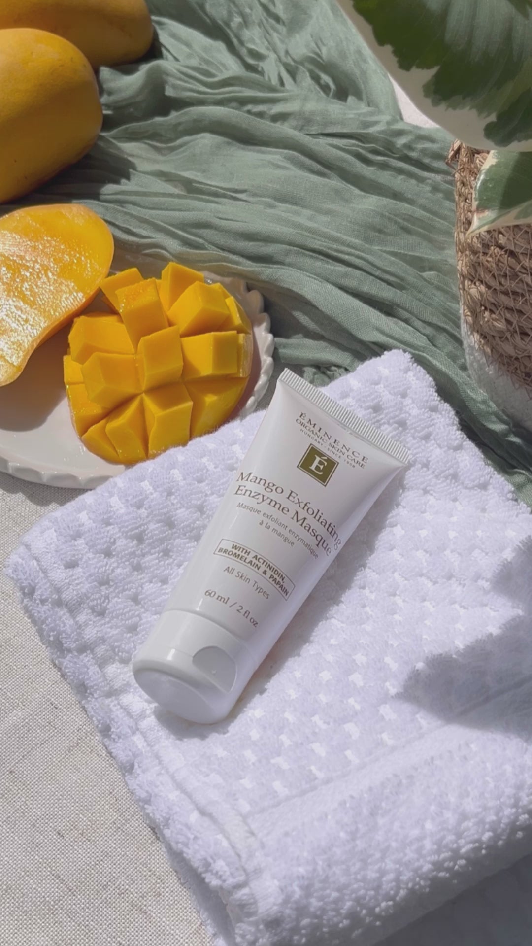 Mango Exfoliating Enzyme Masque on towel with mango