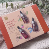 Box of Eminence Organic Essential Serum Trio Gift Set on cozy blanket