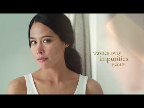 Woman using Eminence Coconut Milk Cleanser